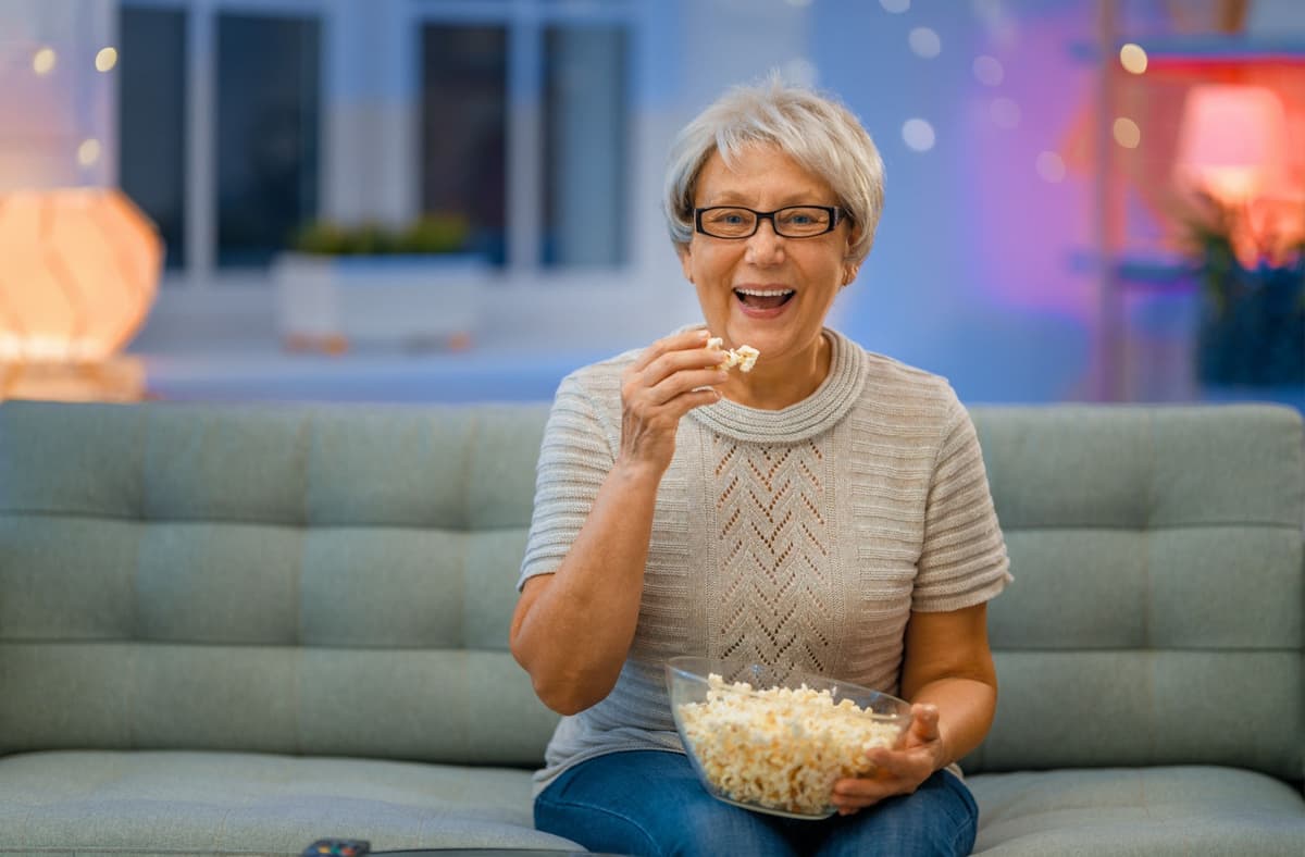 Woman Eating Popcorn - Movies About Retirement